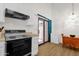 Efficient kitchen featuring white cabinets and appliances, with a sliding glass door to the outside at 3491 N Arizona Ave # 118, Chandler, AZ 85225