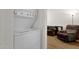 Laundry room with stackable washer and dryer next to living room at 3491 N Arizona Ave # 118, Chandler, AZ 85225