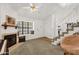 Cozy living room featuring a fireplace, large window, and staircase at 3491 N Arizona Ave # 118, Chandler, AZ 85225
