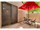Back patio with table and chairs under a red umbrella at 3491 N Arizona Ave # 118, Chandler, AZ 85225
