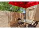 Private outdoor patio with red umbrella and seating area at 3491 N Arizona Ave # 118, Chandler, AZ 85225