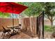 Private outdoor patio with table, chairs, and red umbrella at 3491 N Arizona Ave # 118, Chandler, AZ 85225