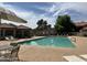 Community pool with lounge chairs and shaded seating areas on a sunny day at 3491 N Arizona Ave # 118, Chandler, AZ 85225
