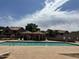 Clean community pool with seating area and well-maintained complex exterior view at 3491 N Arizona Ave # 118, Chandler, AZ 85225