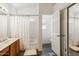 Bathroom with a shower/tub combo, a wood vanity, and a doorway leading to a closet at 3605 W Pecos Rd, Chandler, AZ 85226