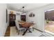 Dining area with a wooden table and chairs, decorative shelving, and sliding glass door to the backyard at 3605 W Pecos Rd, Chandler, AZ 85226