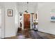 Inviting foyer with tile flooring, a decorative light fixture, and a beautiful wood front door at 3605 W Pecos Rd, Chandler, AZ 85226