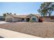Inviting single-story home with desert landscaping, a two-car garage and a quaint front porch at 3605 W Pecos Rd, Chandler, AZ 85226