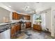 Cozy kitchen with wood cabinets, stainless steel appliances, and a window overlooking the backyard at 3605 W Pecos Rd, Chandler, AZ 85226