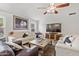 Bright living room featuring tile floors, comfortable seating, and a media console for entertainment at 3605 W Pecos Rd, Chandler, AZ 85226