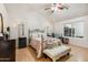 Bedroom featuring a metal frame bed, a ceiling fan, and a window with backyard views at 3605 W Pecos Rd, Chandler, AZ 85226