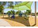 Modern playground with climbing structures and a shaded seating area at 3605 W Pecos Rd, Chandler, AZ 85226