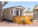 Charming shed with a small wooden deck, perfect for storage or a cozy retreat in the backyard at 3605 W Pecos Rd, Chandler, AZ 85226