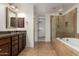 Bathroom featuring a soaking tub, glass shower, and granite countertop vanity at 36600 N Cave Creek Rd # C7, Cave Creek, AZ 85331