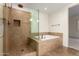 Bathroom featuring a glass walk-in shower and tiled tub at 36600 N Cave Creek Rd # C7, Cave Creek, AZ 85331