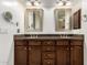 Bathroom featuring double sinks, dark wood cabinetry, and granite countertops at 36600 N Cave Creek Rd # C7, Cave Creek, AZ 85331