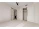 Bedroom featuring neutral carpet, access to bathroom, and a closet at 36600 N Cave Creek Rd # C7, Cave Creek, AZ 85331