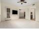Bedroom featuring tiled carpet, ceiling fan, TV, and ensuite bathroom access at 36600 N Cave Creek Rd # C7, Cave Creek, AZ 85331