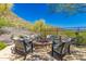 Outdoor seating area with a cozy firepit and comfortable seating surrounded by desert landscaping at 36600 N Cave Creek Rd # C7, Cave Creek, AZ 85331
