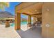 Community pool with covered seating area, lush landscaping, and mountain views in the background at 36600 N Cave Creek Rd # C7, Cave Creek, AZ 85331