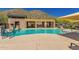 Resort-style pool featuring lounge chairs, covered seating and mountain views in the distance at 36600 N Cave Creek Rd # C7, Cave Creek, AZ 85331