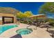 Pool area featuring a hot tub, lounge chairs, an umbrella, and a covered dining area at 36600 N Cave Creek Rd # C7, Cave Creek, AZ 85331