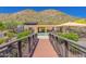 Community pool view showcasing a bridge entrance with mountain views on a beautiful sunny day at 36600 N Cave Creek Rd # C7, Cave Creek, AZ 85331