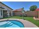 An inviting backyard offers ample space for relaxation and entertainment, enhanced by lush green artificial grass at 3812 W Carlos Ln, San Tan Valley, AZ 85144