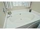 A stylish soaking tub is complemented by elegant fixtures, decorative accents, and a glass block window at 3812 W Carlos Ln, San Tan Valley, AZ 85144
