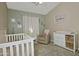 Charming Bedroom with a crib, changing table, and calming decor, creating a cozy space at 3812 W Carlos Ln, San Tan Valley, AZ 85144