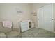 Neutral Bedroom with a cozy chair, white dresser, and calming decor, creating a serene space at 3812 W Carlos Ln, San Tan Valley, AZ 85144