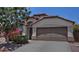 Charming home featuring a two-car garage, desert landscaping, and a well-maintained front yard at 3812 W Carlos Ln, San Tan Valley, AZ 85144
