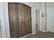 Hallway featuring a modern sliding barn door and a peek into a carpeted room at 3812 W Carlos Ln, San Tan Valley, AZ 85144