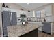 Beautiful kitchen with white cabinetry, granite countertops, stainless steel appliances and center island at 3812 W Carlos Ln, San Tan Valley, AZ 85144