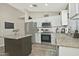 Modern kitchen with stainless steel appliances, granite countertops, and a functional center island, offering style and practicality at 3812 W Carlos Ln, San Tan Valley, AZ 85144