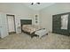 A comfortable bedroom showcases a bed with decorative pillows, a bench, and a sleek chest of drawers at 3812 W Carlos Ln, San Tan Valley, AZ 85144