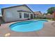 A private backyard pool with pristine turquoise waters is surrounded by a well-manicured patio and lush landscaping at 3812 W Carlos Ln, San Tan Valley, AZ 85144