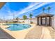 Backyard oasis featuring pool, gazebo, shed, and mature landscaping at 4028 W El Camino Dr, Phoenix, AZ 85051