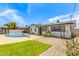Charming backyard featuring a pristine pool and grassy area, perfect for outdoor leisure and social gatherings at 4028 W El Camino Dr, Phoenix, AZ 85051