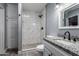 Bathroom features granite countertops, white cabinets, and tile shower with black hardware at 4028 W El Camino Dr, Phoenix, AZ 85051
