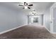 Large bedroom with neutral carpet, ceiling fan, and window with view at 4028 W El Camino Dr, Phoenix, AZ 85051