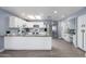 Spacious eat-in kitchen with island features white cabinets and stainless steel refrigerator at 4028 W El Camino Dr, Phoenix, AZ 85051