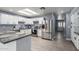Kitchen features white cabinets, granite countertops and stainless steel refrigerator at 4028 W El Camino Dr, Phoenix, AZ 85051