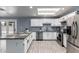Kitchen features white cabinets, granite countertops and stainless steel appliances at 4028 W El Camino Dr, Phoenix, AZ 85051