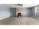 Spacious living room with fireplace, featuring tile flooring, ceiling fan and natural light at 4028 W El Camino Dr, Phoenix, AZ 85051
