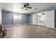Spacious living room with fireplace, featuring tile flooring, ceiling fan and natural light at 4028 W El Camino Dr, Phoenix, AZ 85051