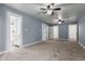 Spacious main bedroom with ceiling fan, neutral carpet and access to en-suite bathroom at 4028 W El Camino Dr, Phoenix, AZ 85051