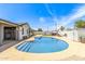 Inviting pool area with a diving board perfect for relaxation and outdoor entertainment under clear blue skies at 4028 W El Camino Dr, Phoenix, AZ 85051