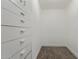 Walk-in closet with custom drawers, shelves, and neutral carpet at 4028 W El Camino Dr, Phoenix, AZ 85051