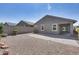Large backyard with gravel, lush green bushes, and a brick-paved patio area at 4218 W Palace Station Rd, New River, AZ 85087